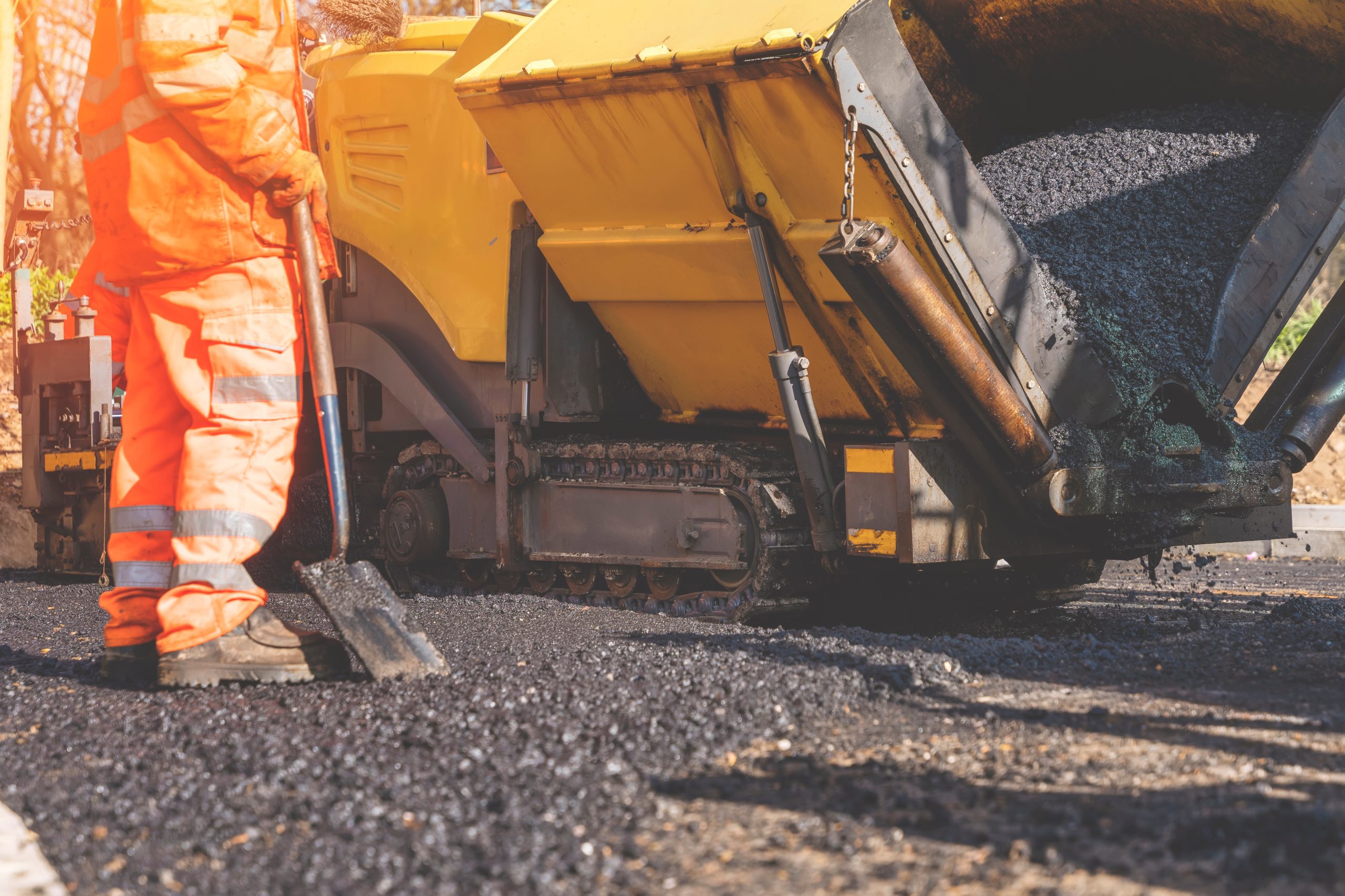 construction,workers,laying,asphalt,on,a,sunny,day,in,a